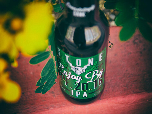Stone Enjoy By 04.20.16 IPA bottle with flowers