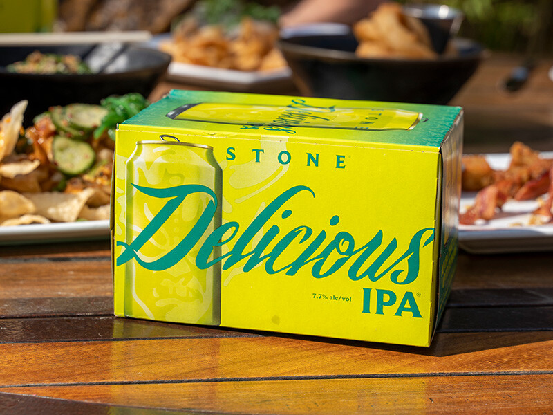 Stone Delicious IPA six-pack on table