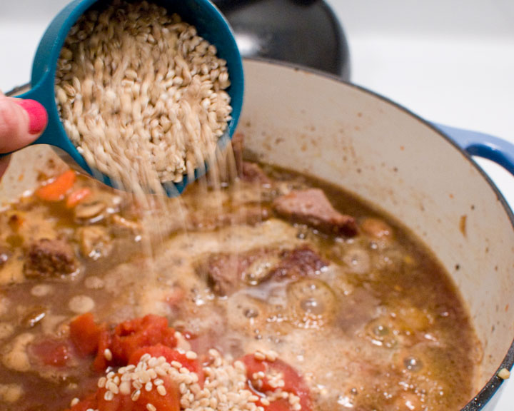 pouring barley into the stew