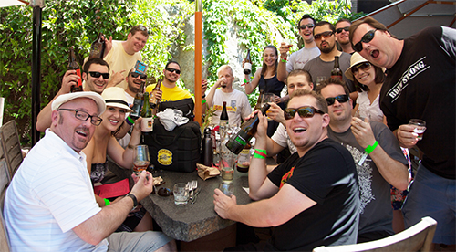 fans sitting at a stone table with beer