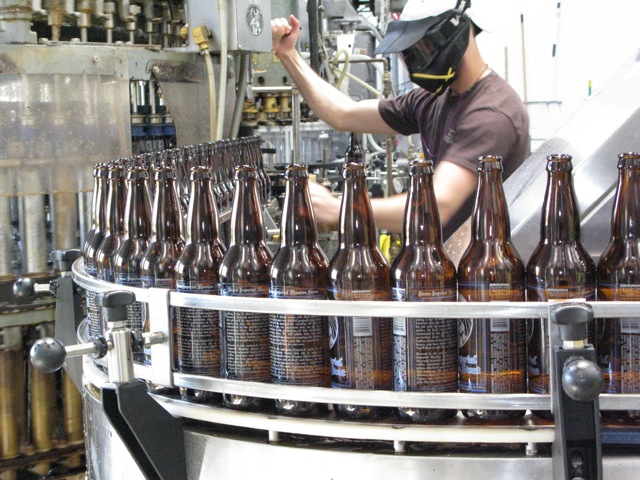 Bottling Line Operator Bryce Williams-Tuttle managing the Filler