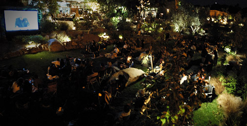 People ready for a movie in the Stone Liberty Station gardens