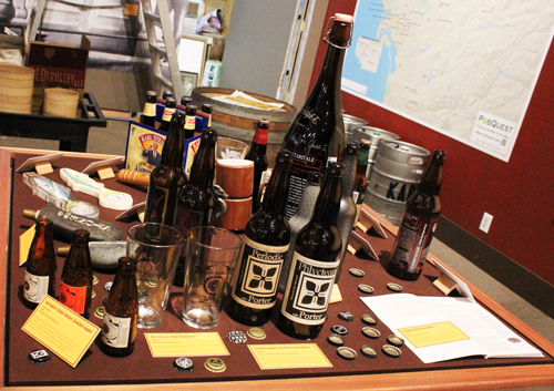 bottles of beer and bottle caps on a table