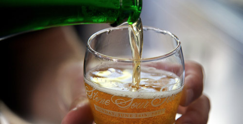 Sour beer being poured into a Stone Sour Fest glass
