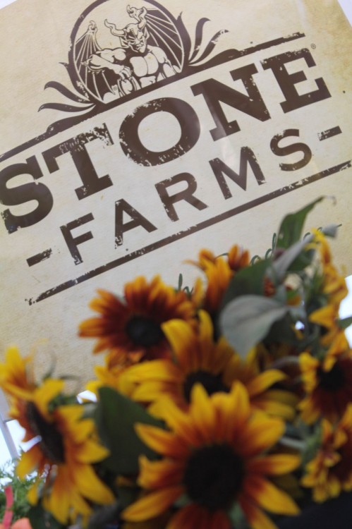 stone farms logo behind flowers