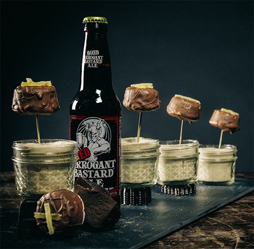 chocolate covered marshmallows in sugar jars next to bottle of oaked arrogant bastard ale