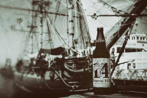 20th Anniversary Encore Series: Stone 14th Anniversary Emperial IPA next to ship in black and white