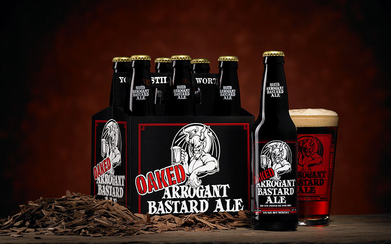 Oaked Arrogant Bastard six-pack and glass