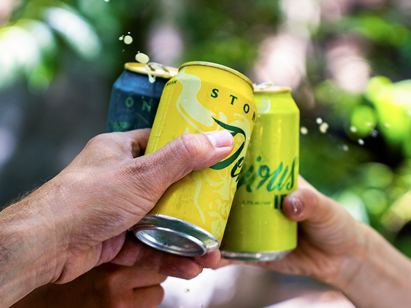 stone delicious mixed pack IPAs being cheers'd together