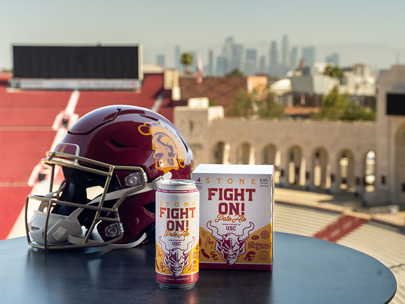 a football helmet next to stone fight on pale ale beer in the USC football stadium