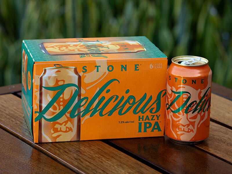 can and six-pack of stone delicious hazy ipa