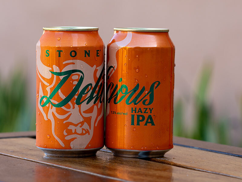 two cans of stone delicious hazy ipa