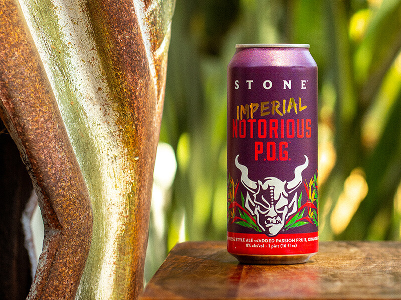 can of Stone Imperial Notorious P.O.G. by a wooden carving