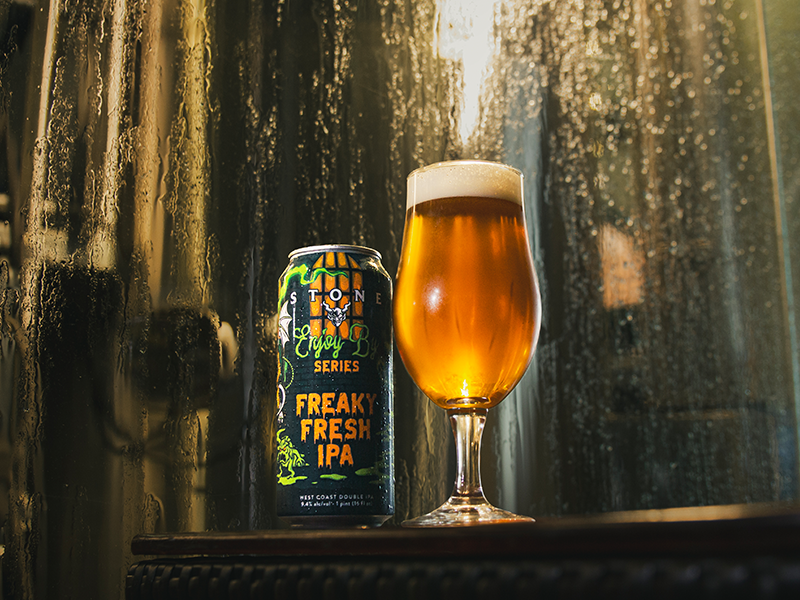 Stone Enjoy By Series: Freaky Fresh can next to beer in glass