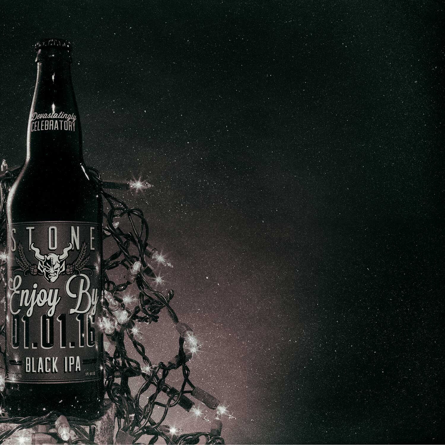 Stone Enjoy By 01.01.16 Black IPA bottle with lights in a starry sky