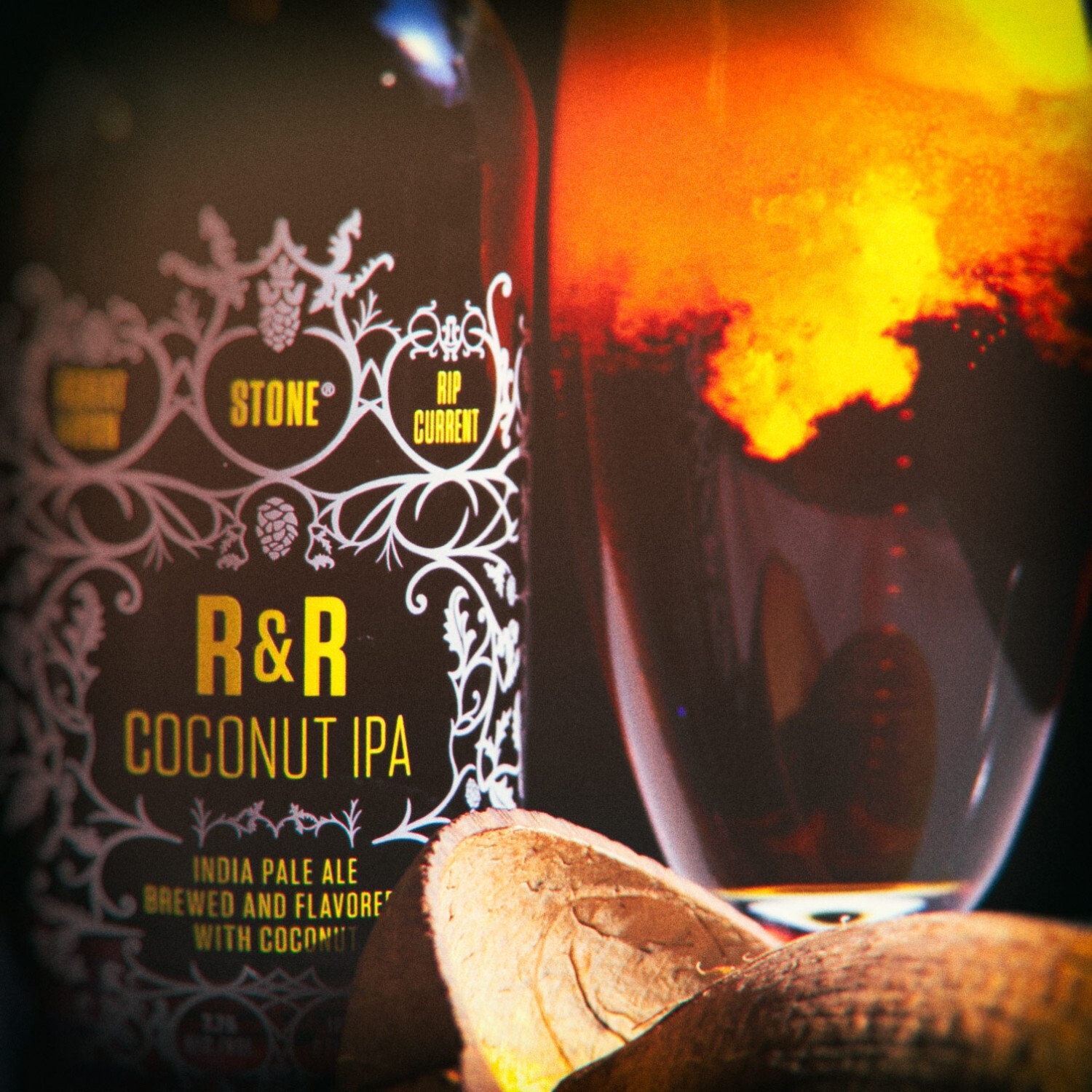 bottle of Robert Masterson & Ryan Reschan / Rip Current / Stone R&R Coconut IPA with bright orange smoke