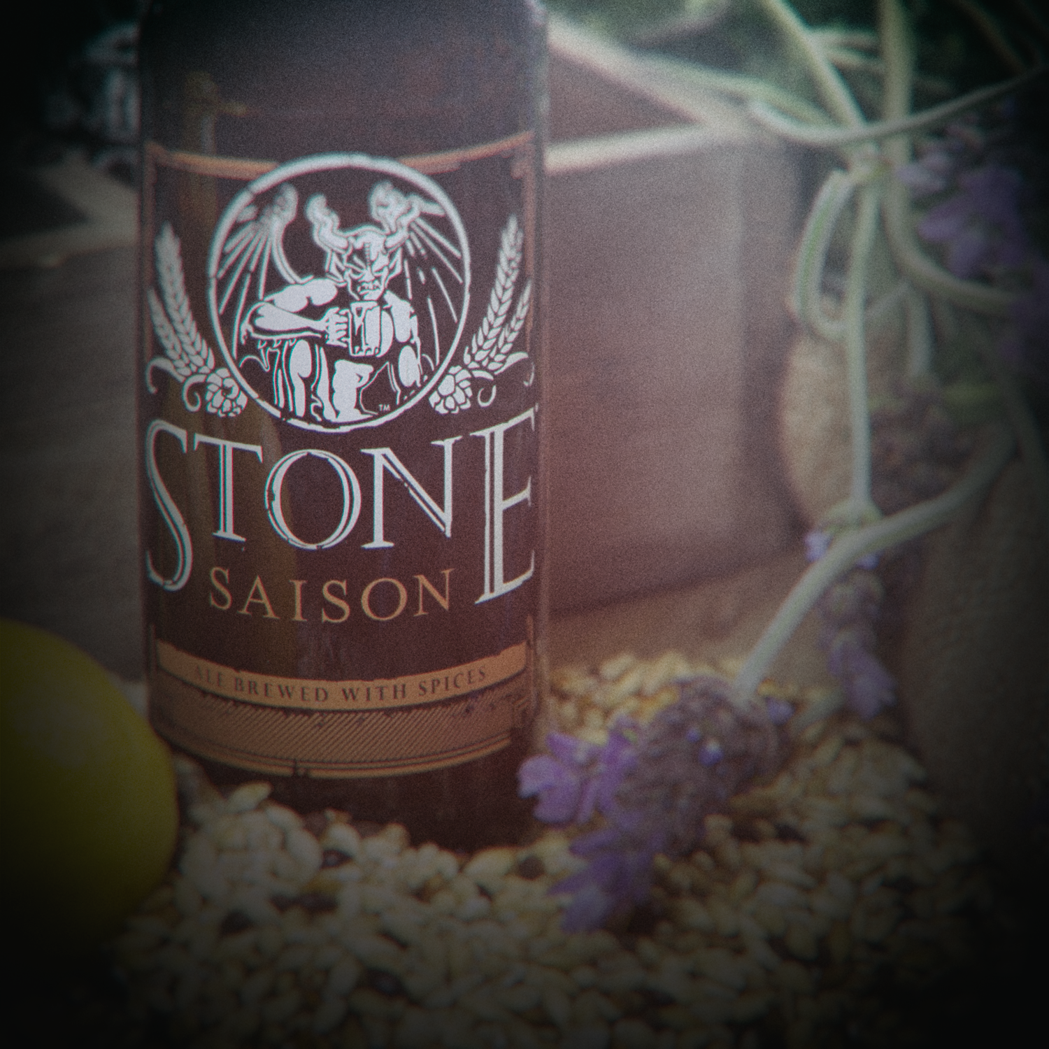 Stone Saison bottle behind shrubs