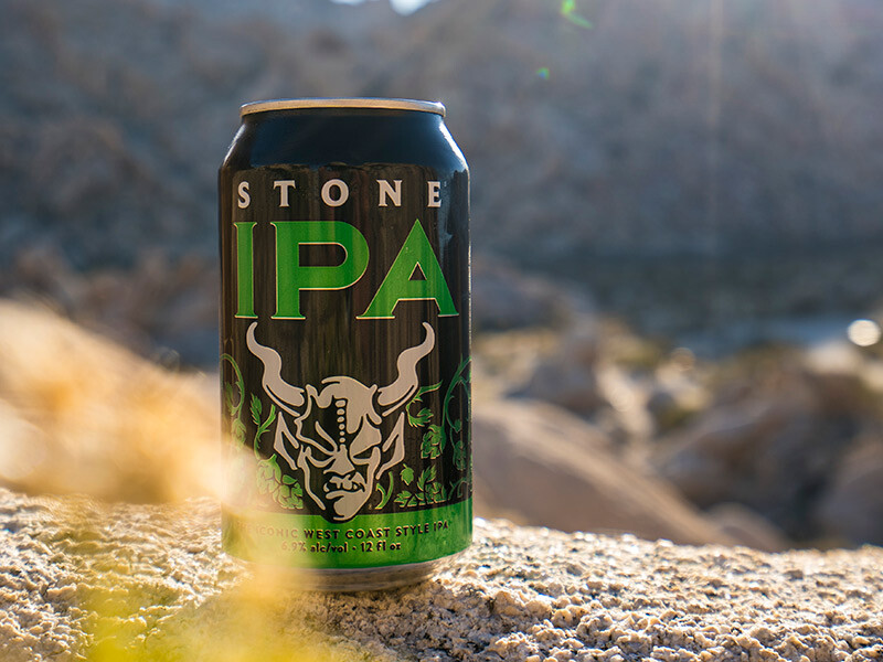 stone IPA can in front of mountains