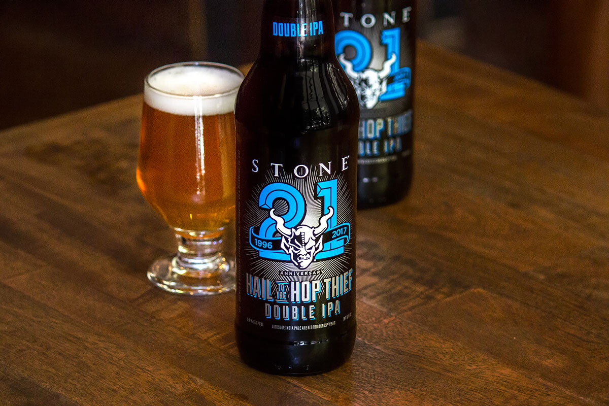 Two bottles and a glass of Stone 21st Anniversary Hail to the Hop Thief Double IPA
