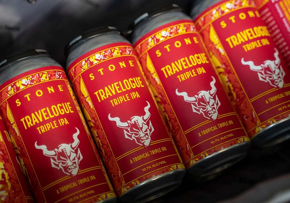 cans of stone travelogue triple IPA in a bag
