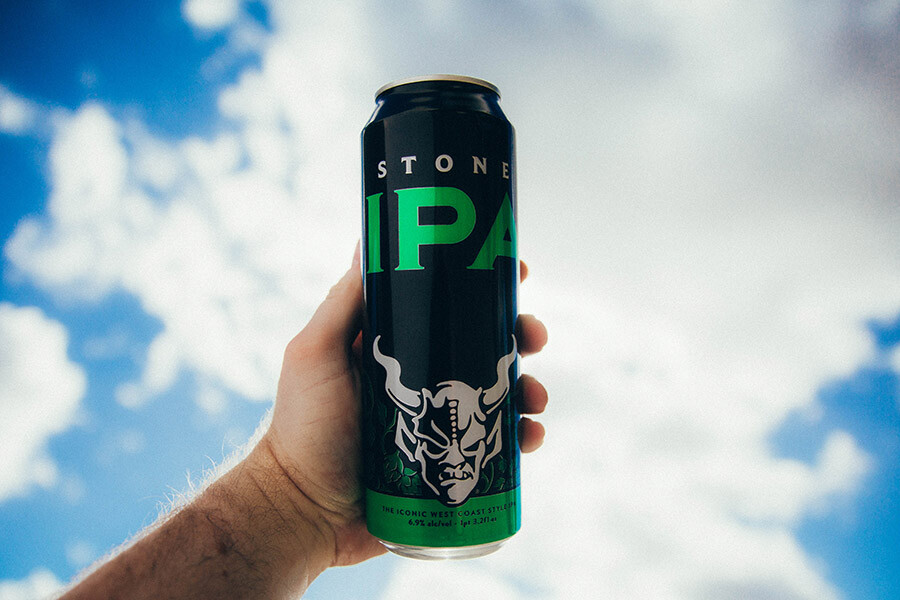 Holding a can of Stone IPA to the sky