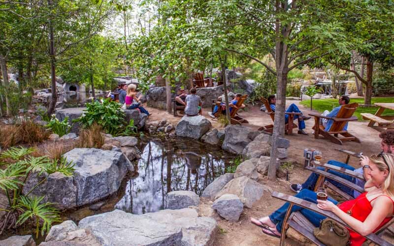 the gardens at stone escondido where people relax outside and drink beer